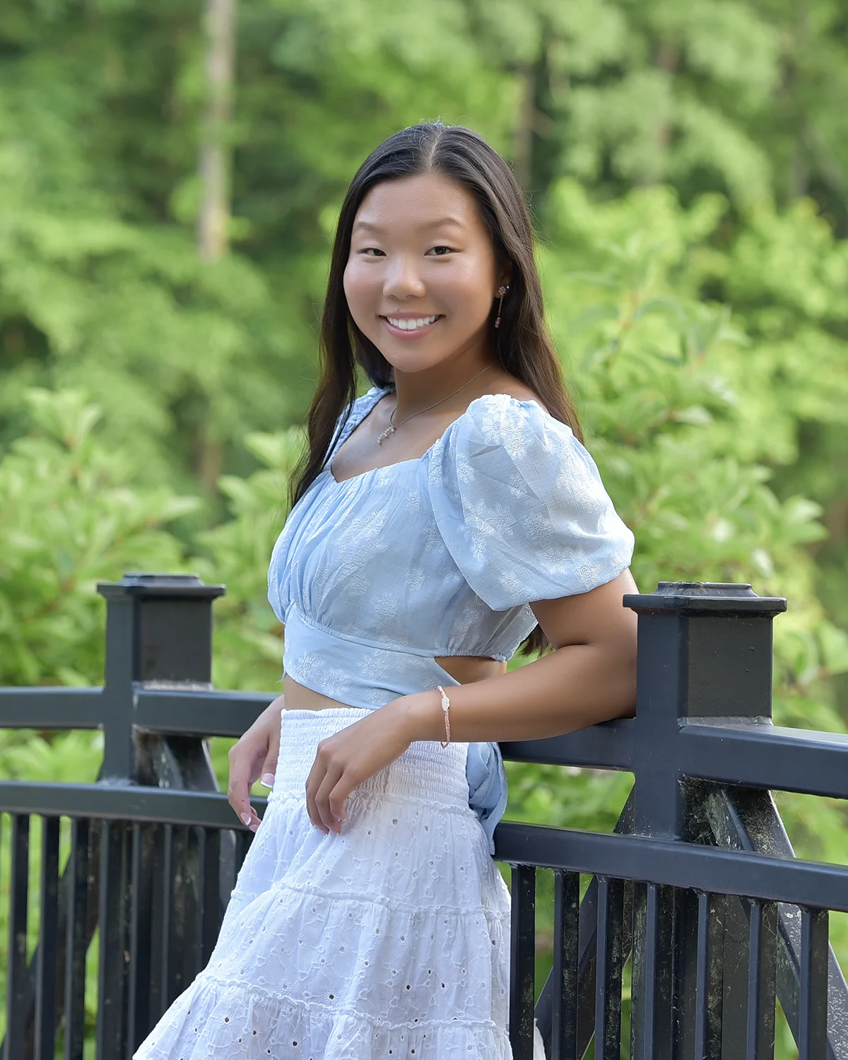 Senior portrait of woman outside on a bridge
